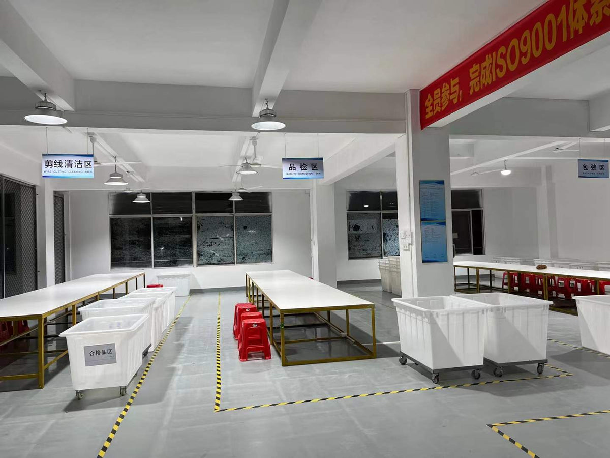 Tables and sorting bins beneath signs for thread trimming, quality inspection and packing.