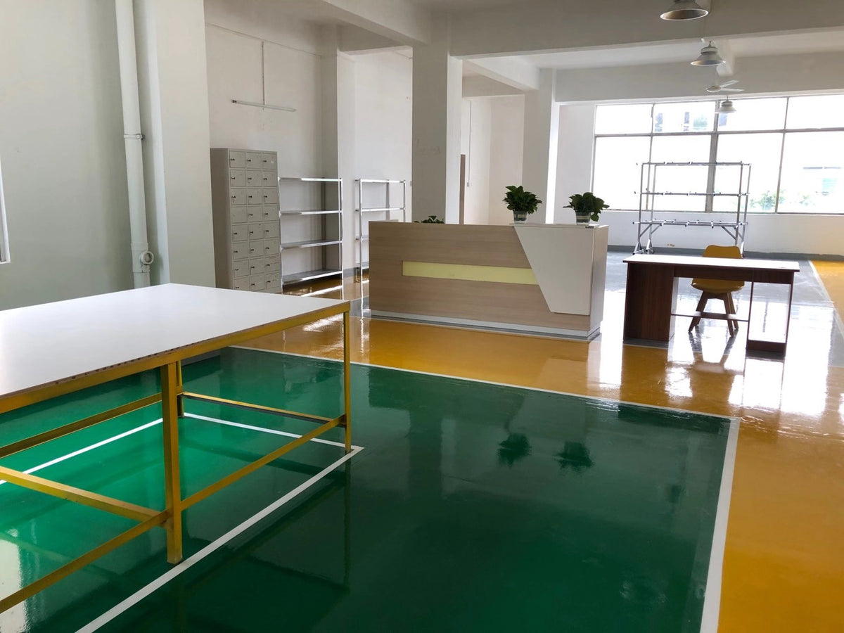 Reception counter, office desk and worktable beside the workshop entrance.