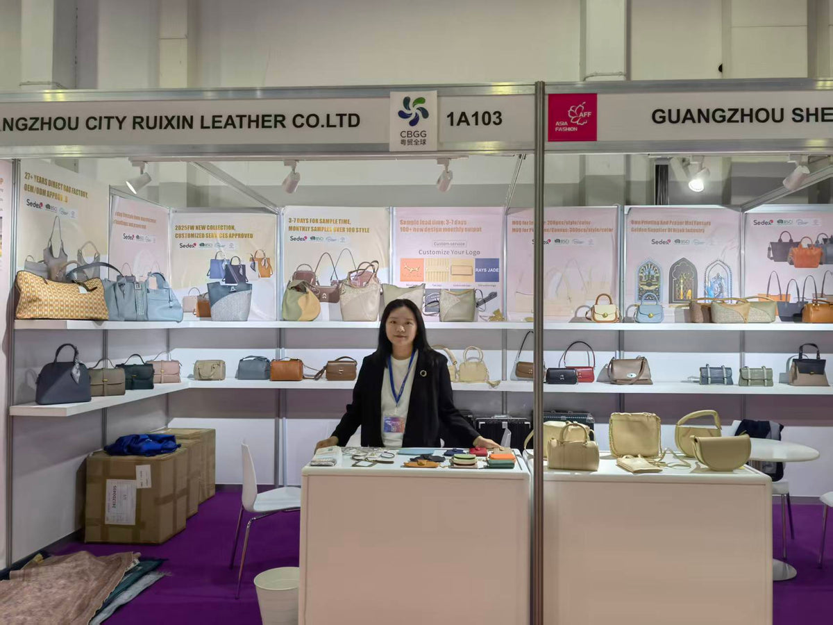 Front view of handbag shelves and an accessory sample counter at a trade show booth.