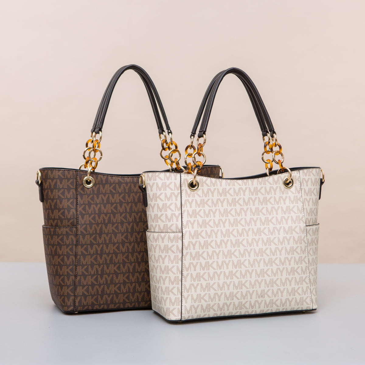 Brown and cream letter-pattern totes with black handles and gold-tone chain links