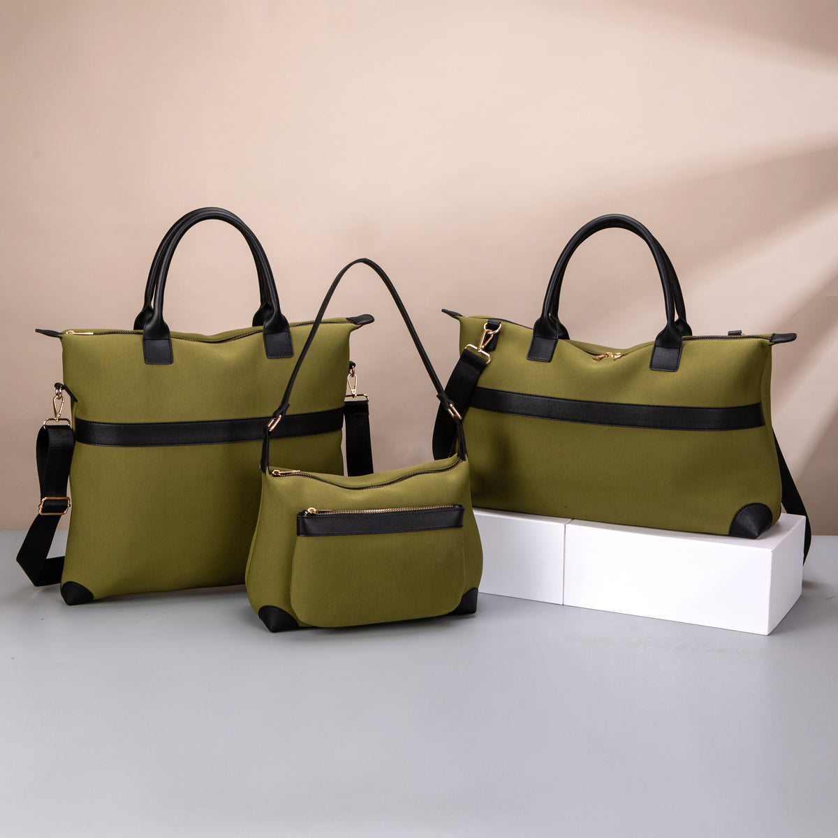 Olive totes and a small shoulder bag with black handles and contrast panels
