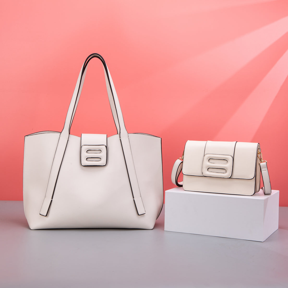 White tote and flap crossbody bags with black edging and cutout tabs