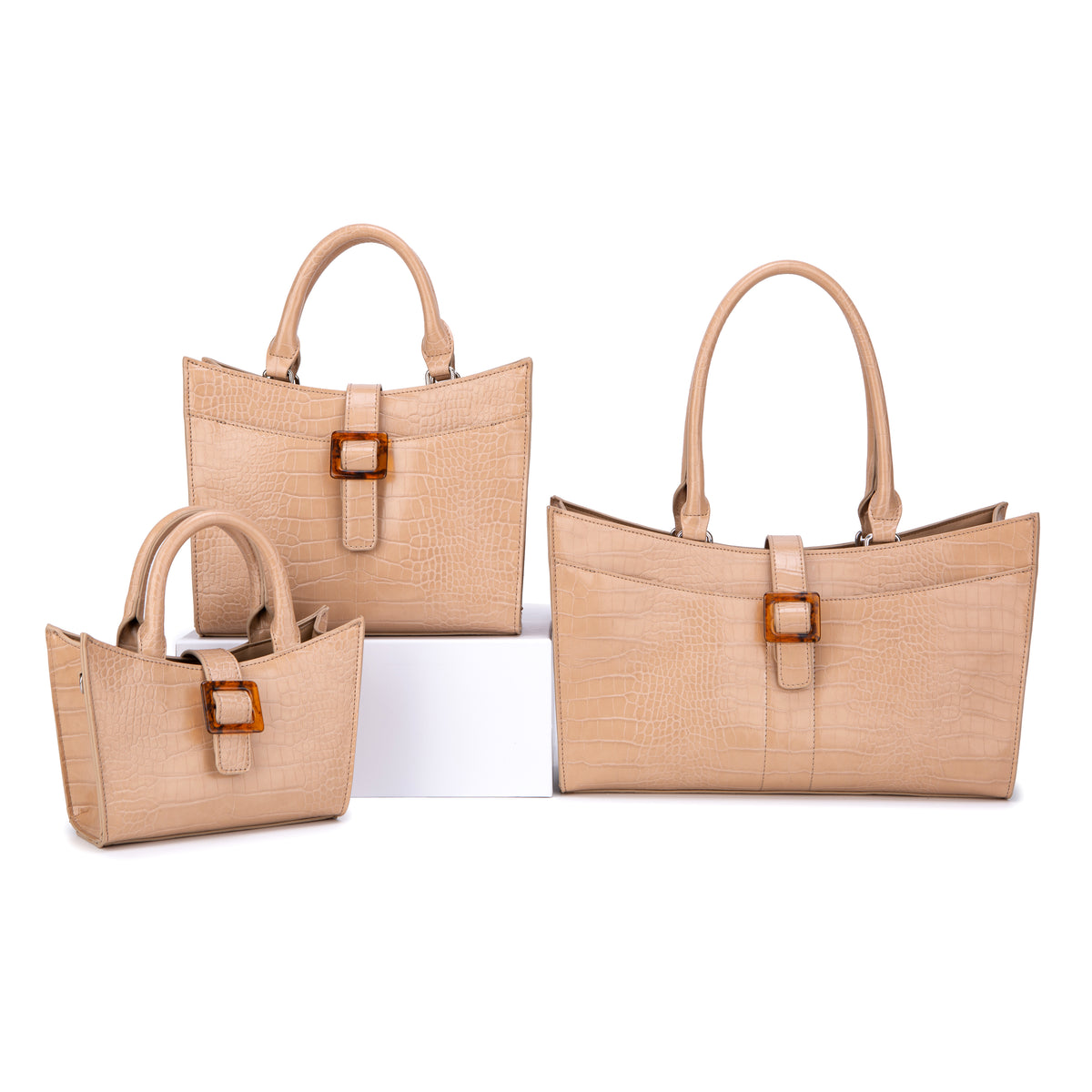 Three beige croc-effect top-handle totes with square buckle tabs
