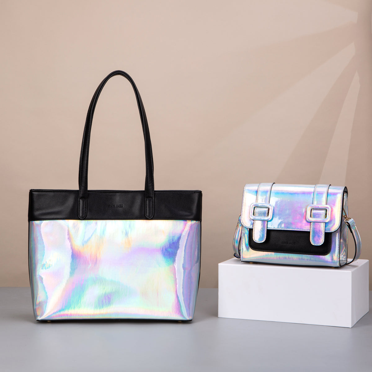 Iridescent silver tote and double-buckle satchel with black trim